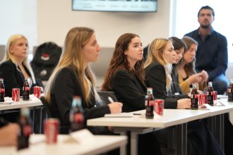 Food marketing students listen to a presentation on the industry tour