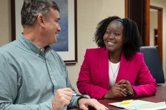 A student at an internship with one of her advisors