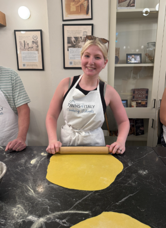 WMU study abroad student, Hannah Templeton, rolls out pizza dough.
