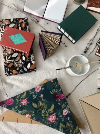 Hand-crafted books strewn on a table. 