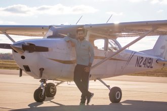 Talal Arshad, Western Michigan University alumnus and local business owner, poses with an aircraft at the WMU College of Aviation