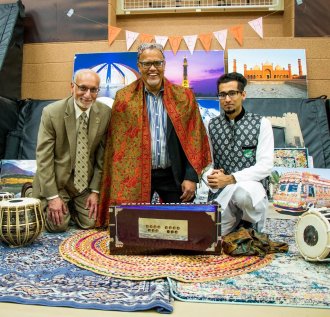 Talal Arshad, Western Michigan University alumnus and local business owner, celebrates a cultural event on campus with former WMU president Dr. Edward Montgomery and former chair of marketing Dr. Mushtaq Luqmani