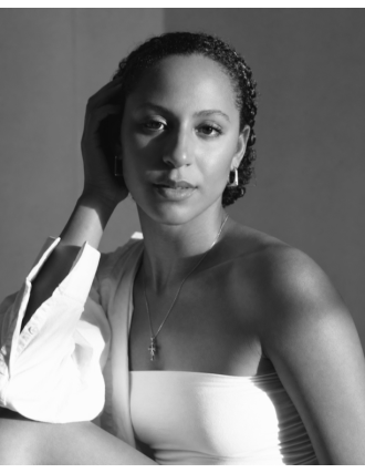 Black and white portrait of a beautiful black woman in a white formal dress. 