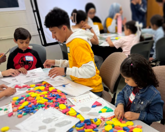Students solving puzzles with colored blocks