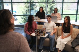 Group of students in a conference room with instructor