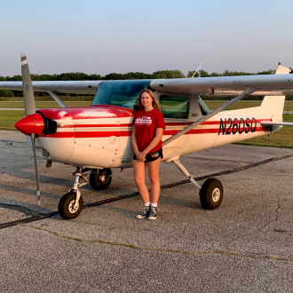 Student in front of plane