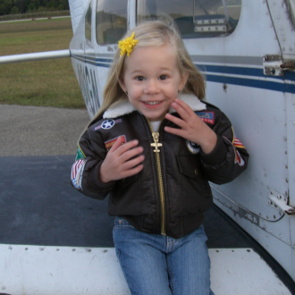 Young student on wing of plane.
