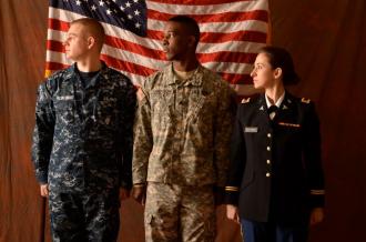 Student veterans in front of flags