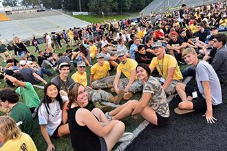 Group of WMU students gathered together on the football field.