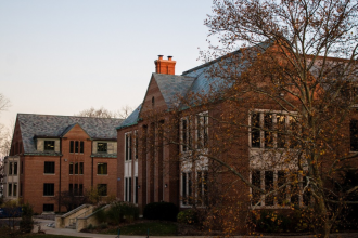 A photograph of Walwood Hall, a red brick building with grey slate roof