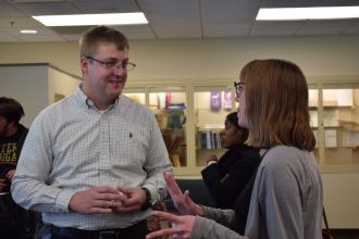 Shane Preston speaking with a WMU student following his talk