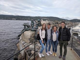 Catherine posing with friends in front of monument in Norway
