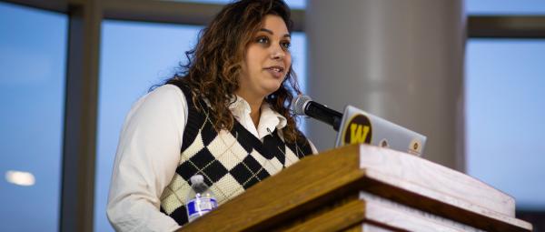A student presenting in the ballroom