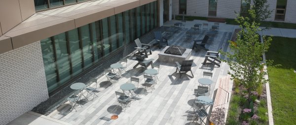 An aerial view of an outdoor courtyard at Valley Oaks with lounge seating and a fire pit.