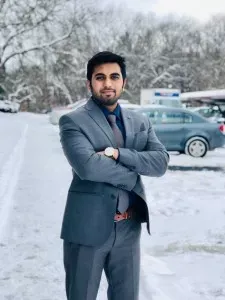 image of man standing outside in a snowy parking lot