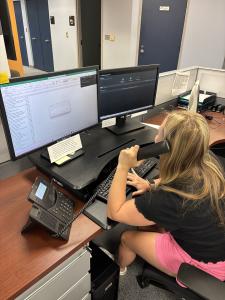 Ellie Lundy working as a Switchboard Student Lead employee at the IT Front Desk, as a swtichboard operator, in the University Computing Center
