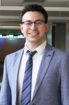 Professional photo of Mihail Naskovski wearing a gray suit