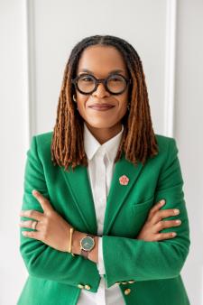 Professional photo of Kenlana Ferguson with her arms crossed in front of a white background