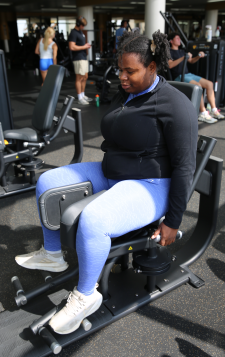 A student works out in the weight room at the SRC