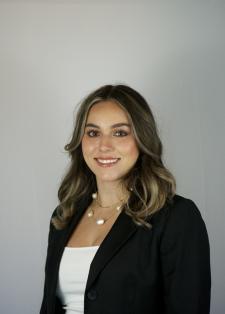 Headshot of Daniela Padilla in a white top and black blazer on a white background