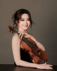 Dr. Sophie Tang posing with violin
