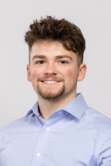 Nathan Clarke wearing a blue shirt against a light background