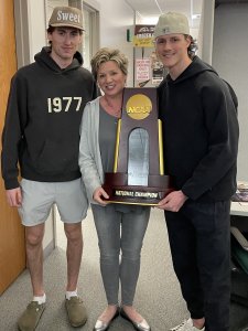 JoAnn Atkin with WMU hockey players and the national championship trophy