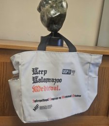 An MIP branded canvas tote bag that reads "Keep Kalamazoo Medieval."
