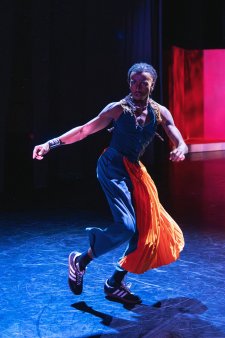 Tyresi Hunte, a Black man, dances on a dance floor in costume.