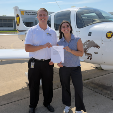 Students with certificate in fron to plane.